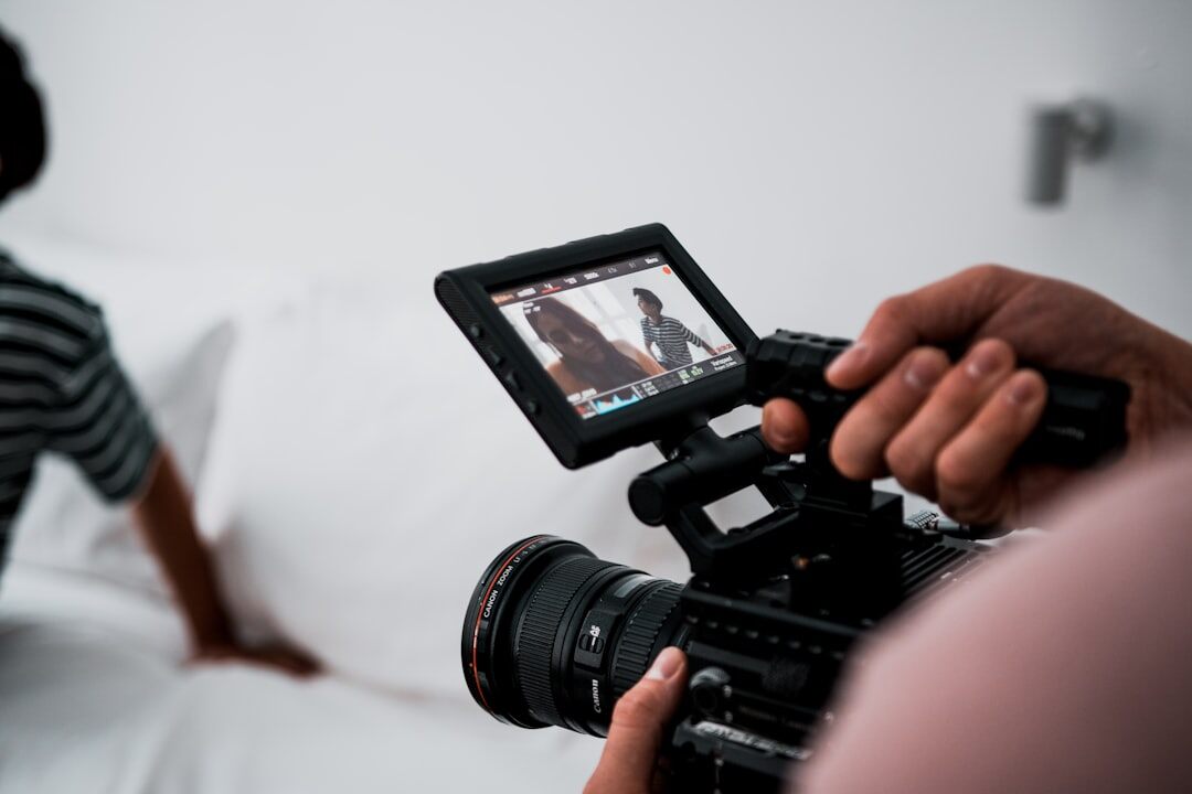 Two people reviewing interview footage on a monitor in an editing suite