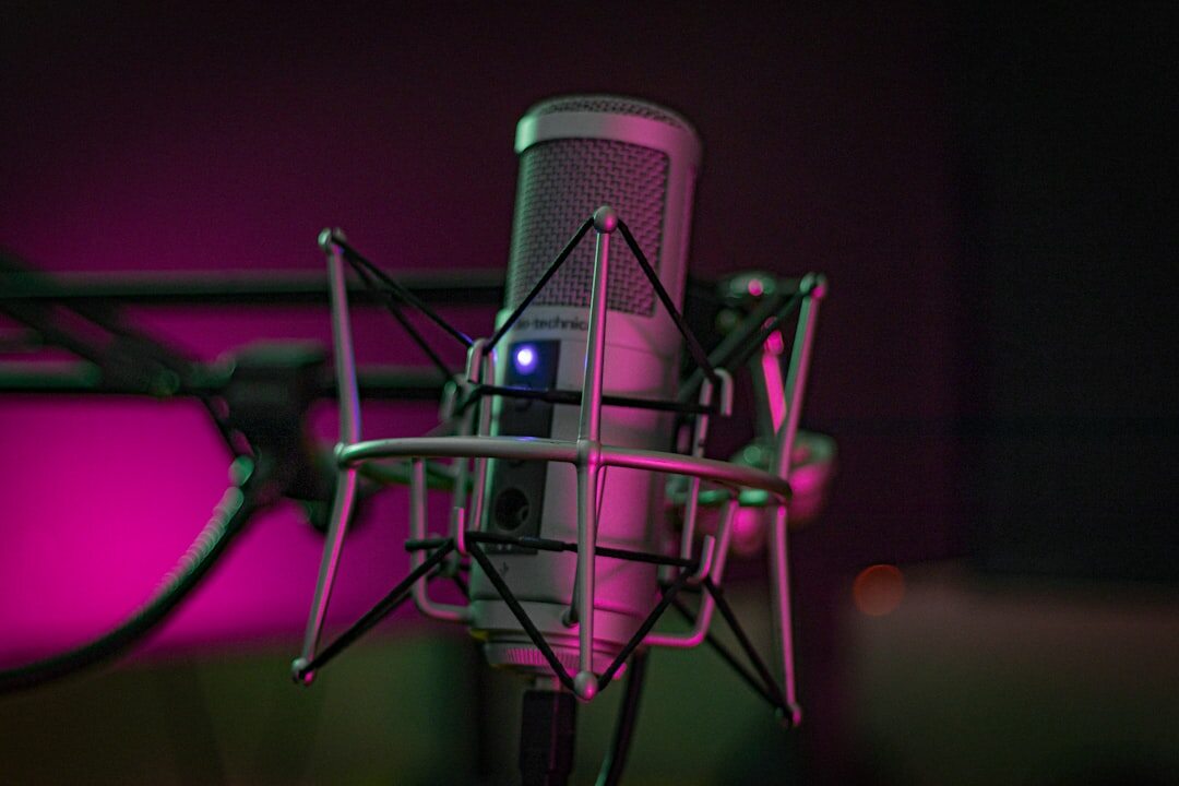 Close-up of a studio microphone with soft warm lighting in the background